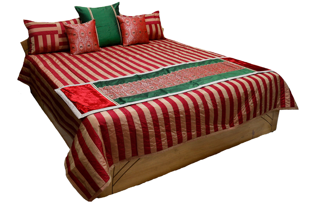 Red and cream striped double bedcover with a green and red brocade runner, matching striped pillow covers and patterned cushion covers