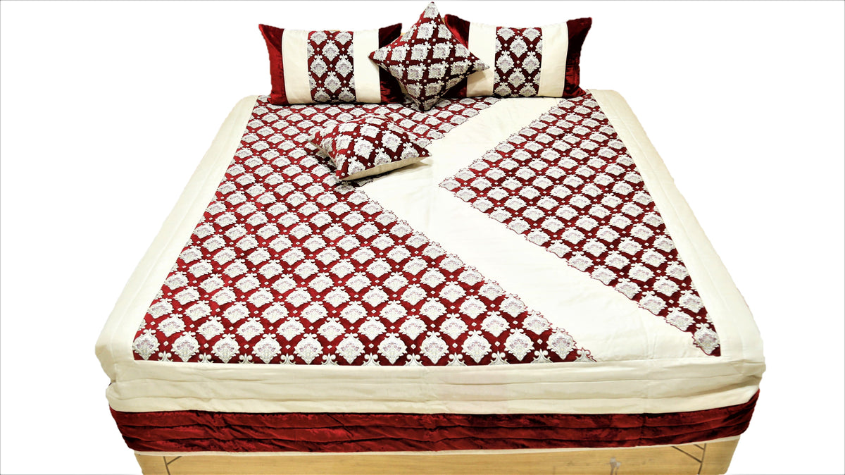 Maroon and cream quilted bedcover set with the corner turned back over the bed