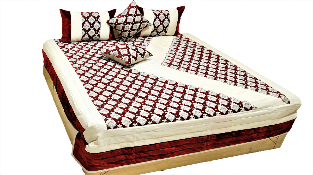 Maroon and cream traditional print quilted bedcover set made up on a double bed