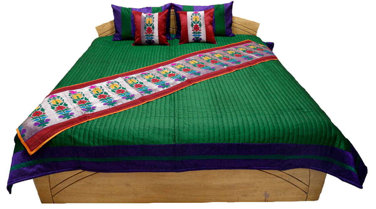 Green side of the reversible bedcover shown flat