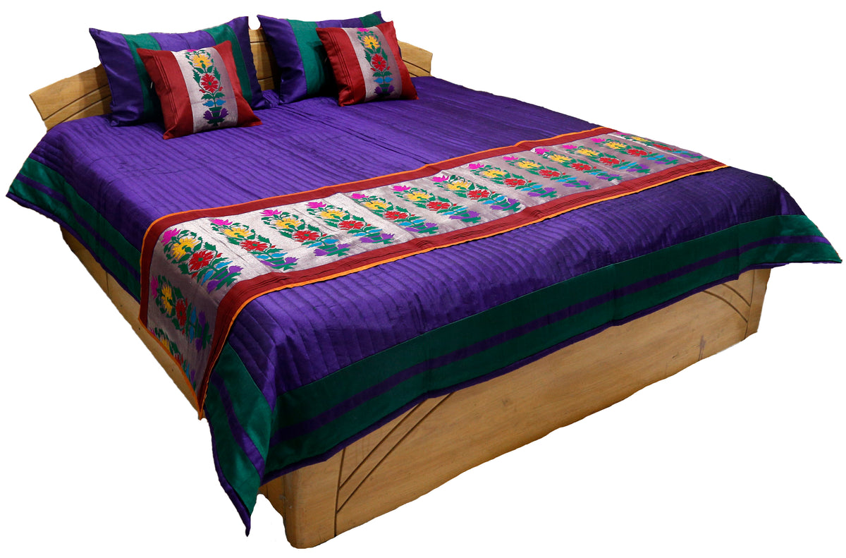 Purple satin-stripe reversible bedcover with a multicolour floral-embroidered runner and matching cushions
