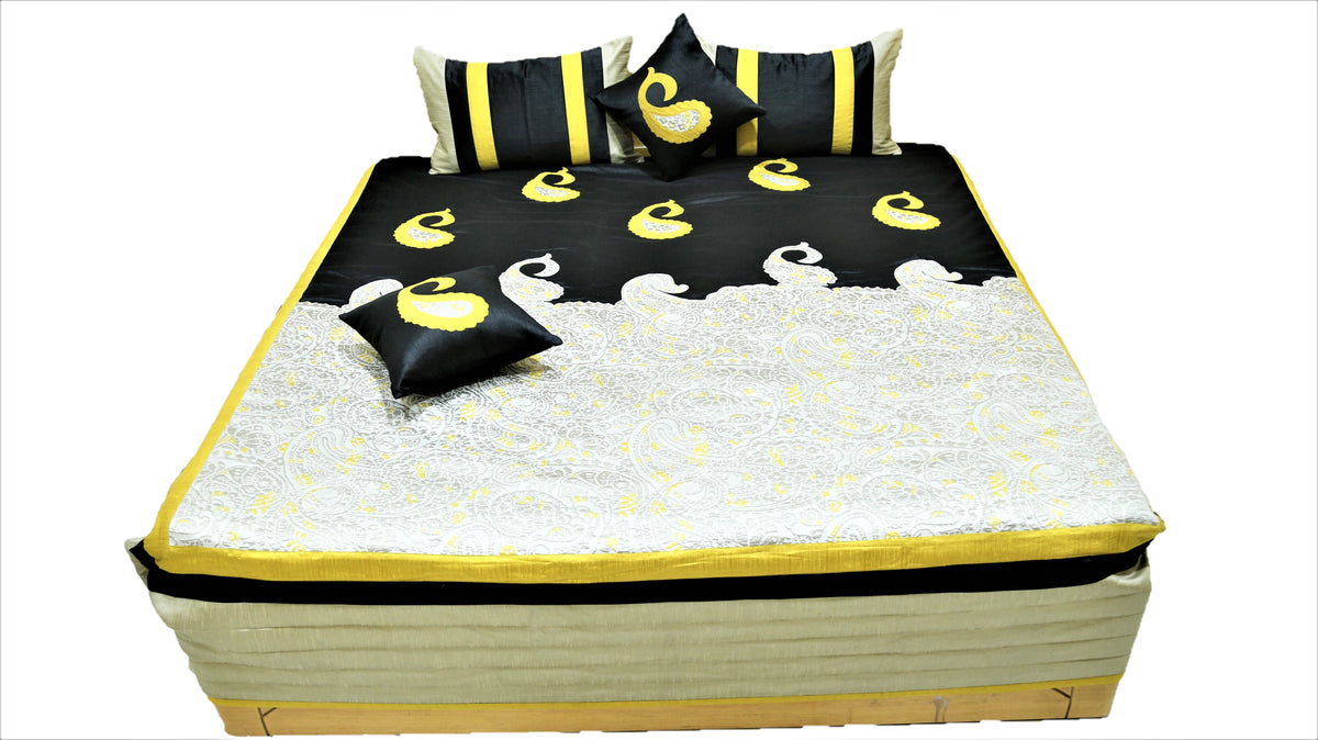Black and ivory paisley bedcover flat view with striped bolster and cushion covers