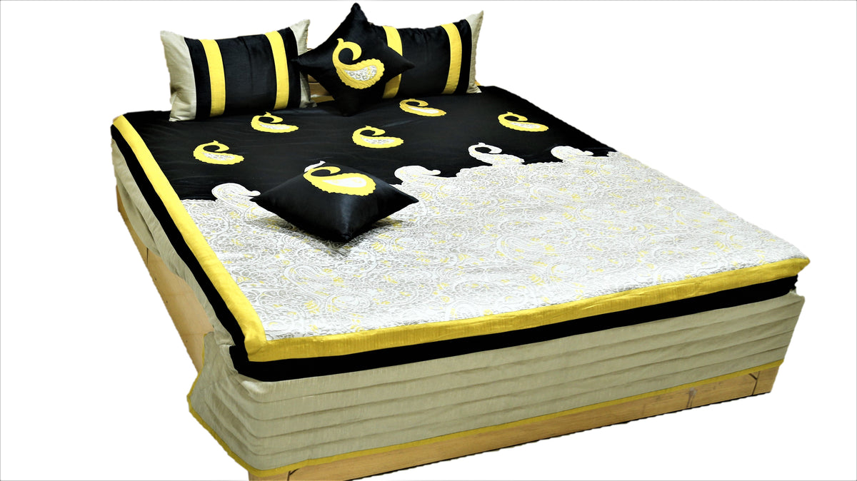 Black silk bedcover with yellow paisley applique and ivory brocade panel, matching cushions