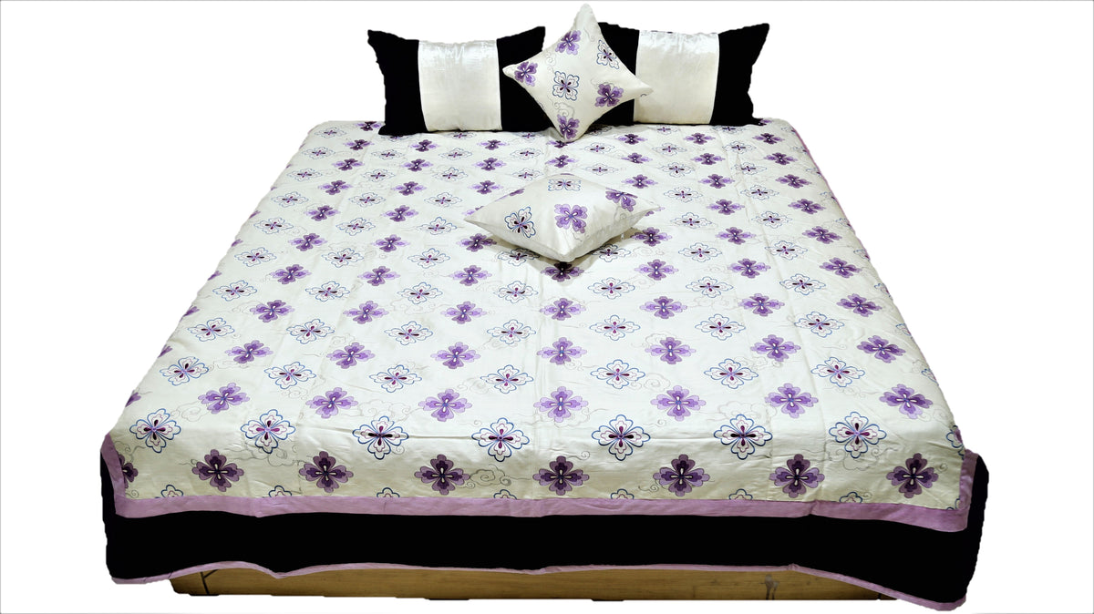 Front view of the white and purple flower quilted bedcover set with matching cushions