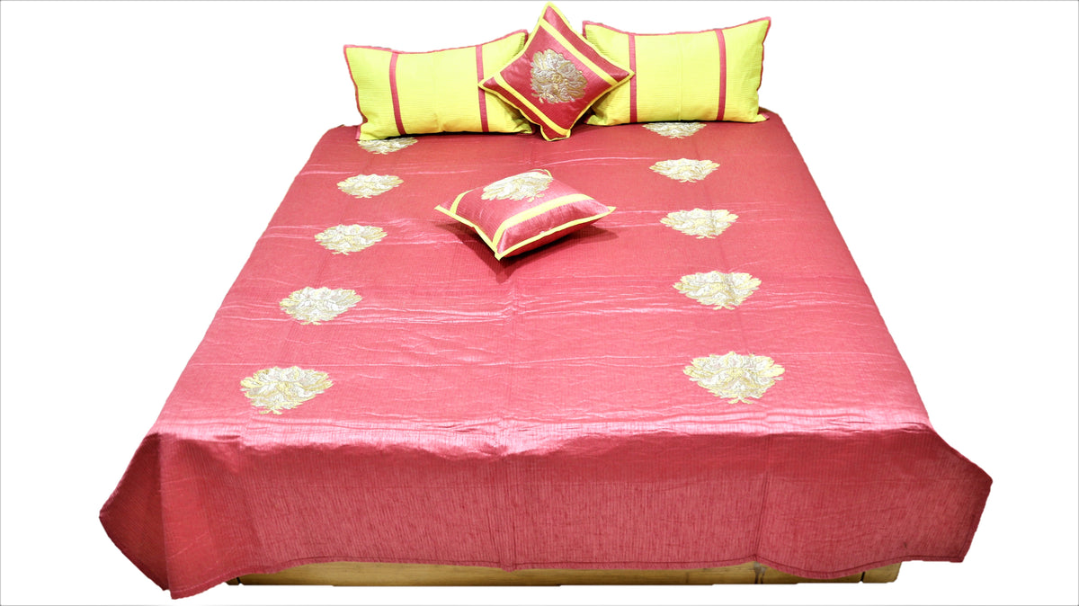 Coral rose bedcover flat view with lemon striped bolsters and maroon zari cushions