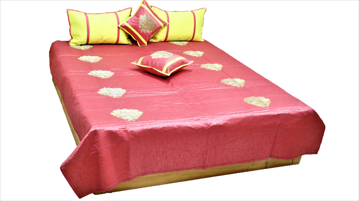 Coral rose silk bedcover with gold and silver zari floral motifs and lemon bolster covers