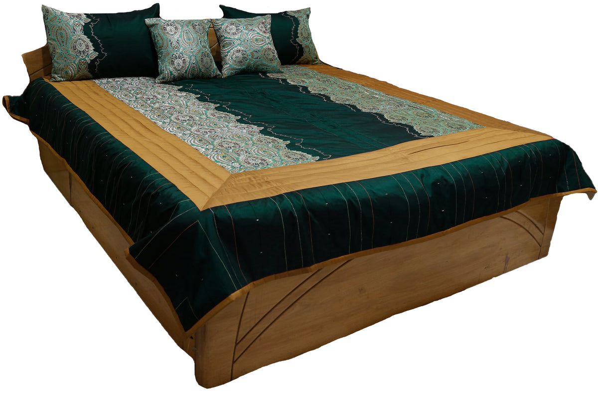 Deep teal silk bedcover with turquoise paisley brocade panels and gold border, angled view