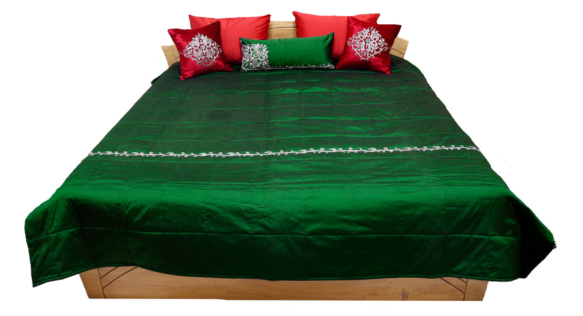Green pearl work bedcover with red and green embroidered cushion covers, straight view