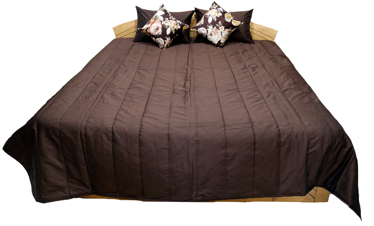 Brown pintucked bedcover with two floral print cushion covers, straight view