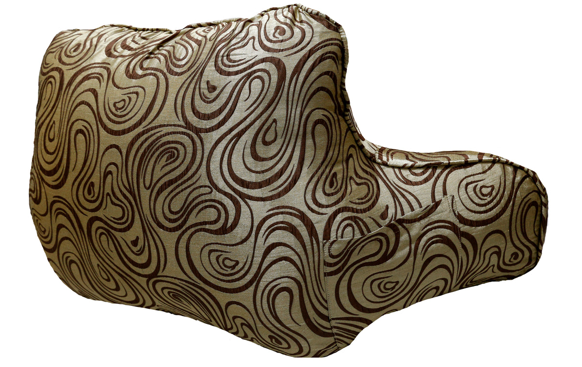 Same gold and brown swirl-print bedrest cushion, side angle showing the armrests