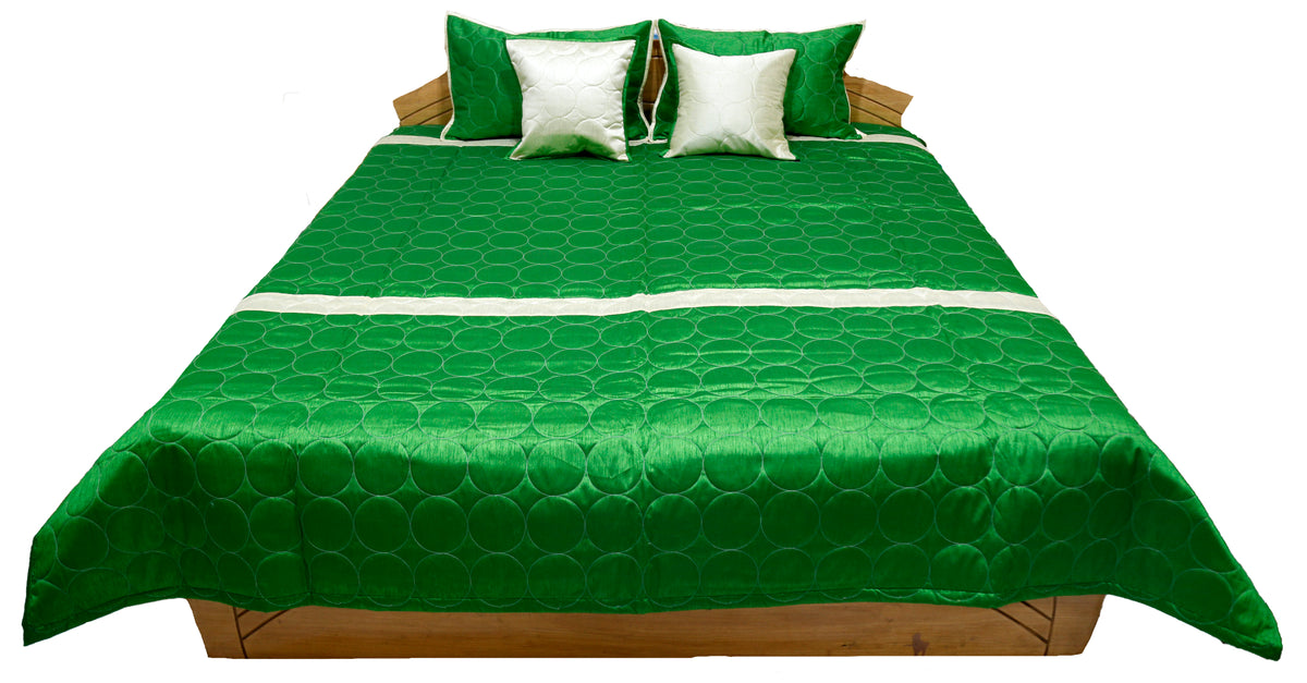 Green circle quilted side laid flat with ivory and green cushion covers