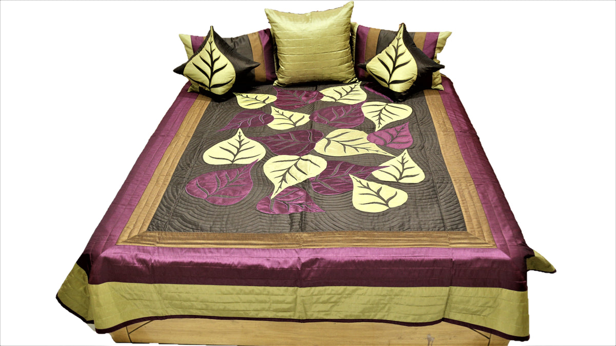 Leaf applique bedcover with olive and aubergine border and leaf cushions, straight view