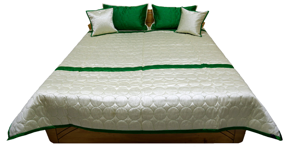 Ivory circle quilted side laid flat with green border and matching cushions