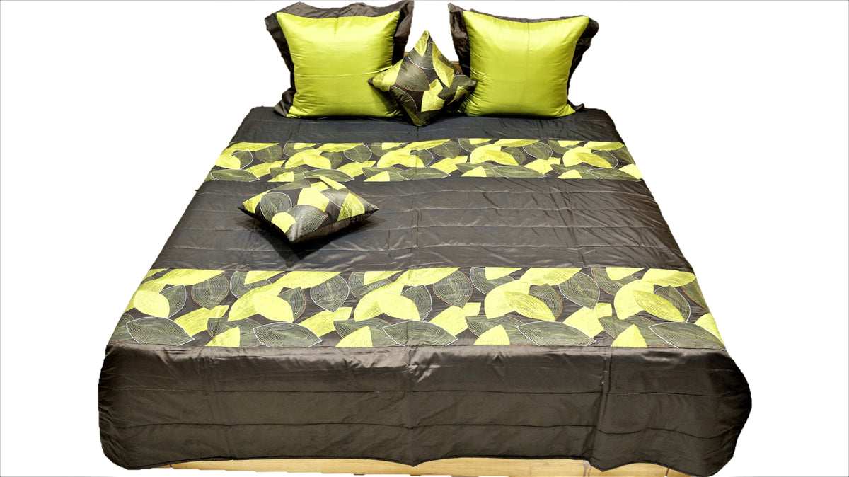 Front view of the brown and lime leaf quilted bedcover set on a double bed