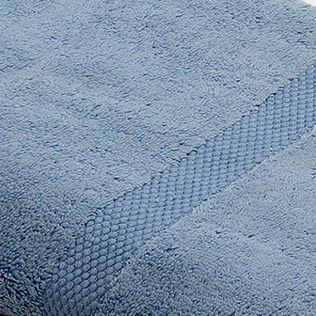 Light blue cotton bath towel folded texture view