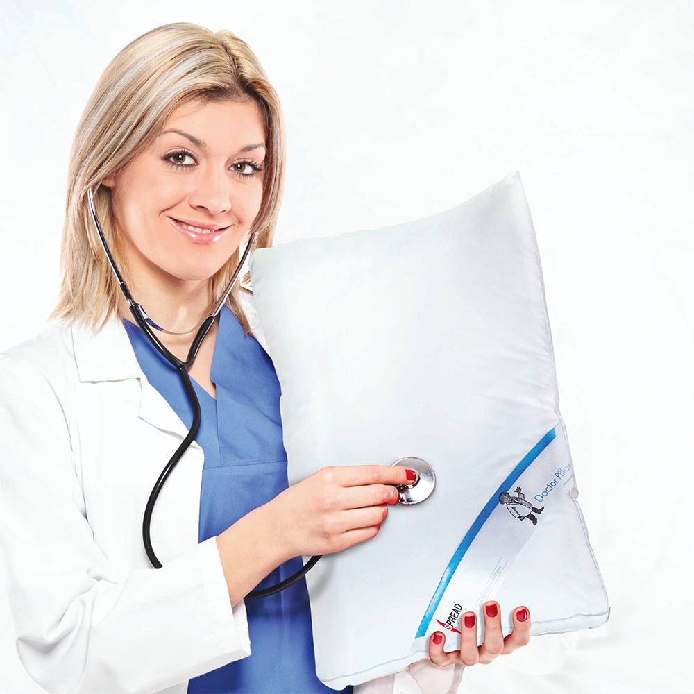 Doctor in a white coat holding a Spread Doctor Pillow with a stethoscope