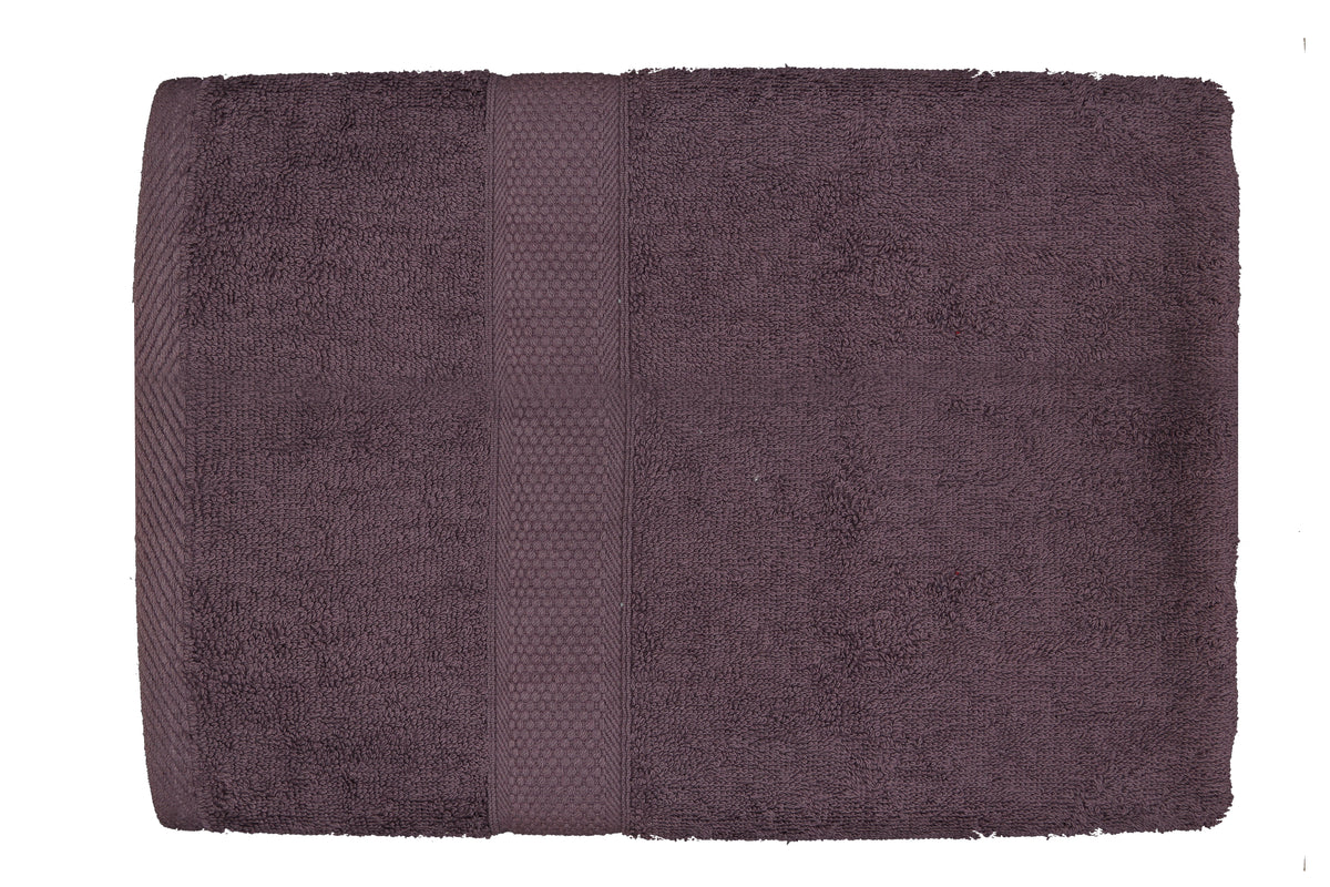 Deep plum-purple cotton bath towel, close-up flat view showing the honeycomb woven border