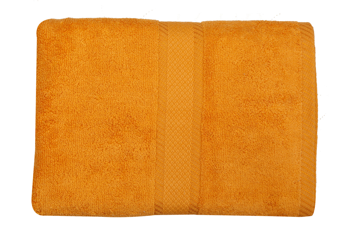Amber-orange cotton bath towel, close-up folded view showing the diamond-weave border