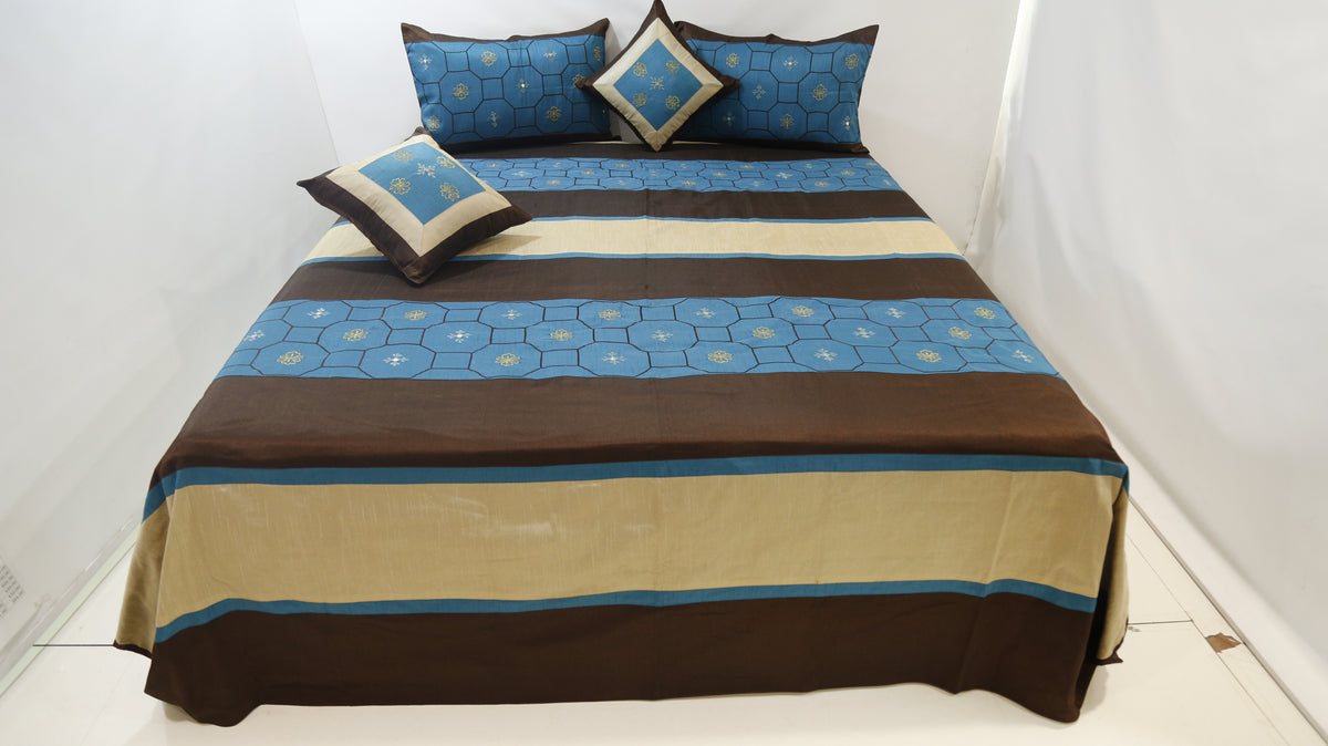 Blue and brown striped dupion silk bedcover with matching pillow covers and cushions on a bed