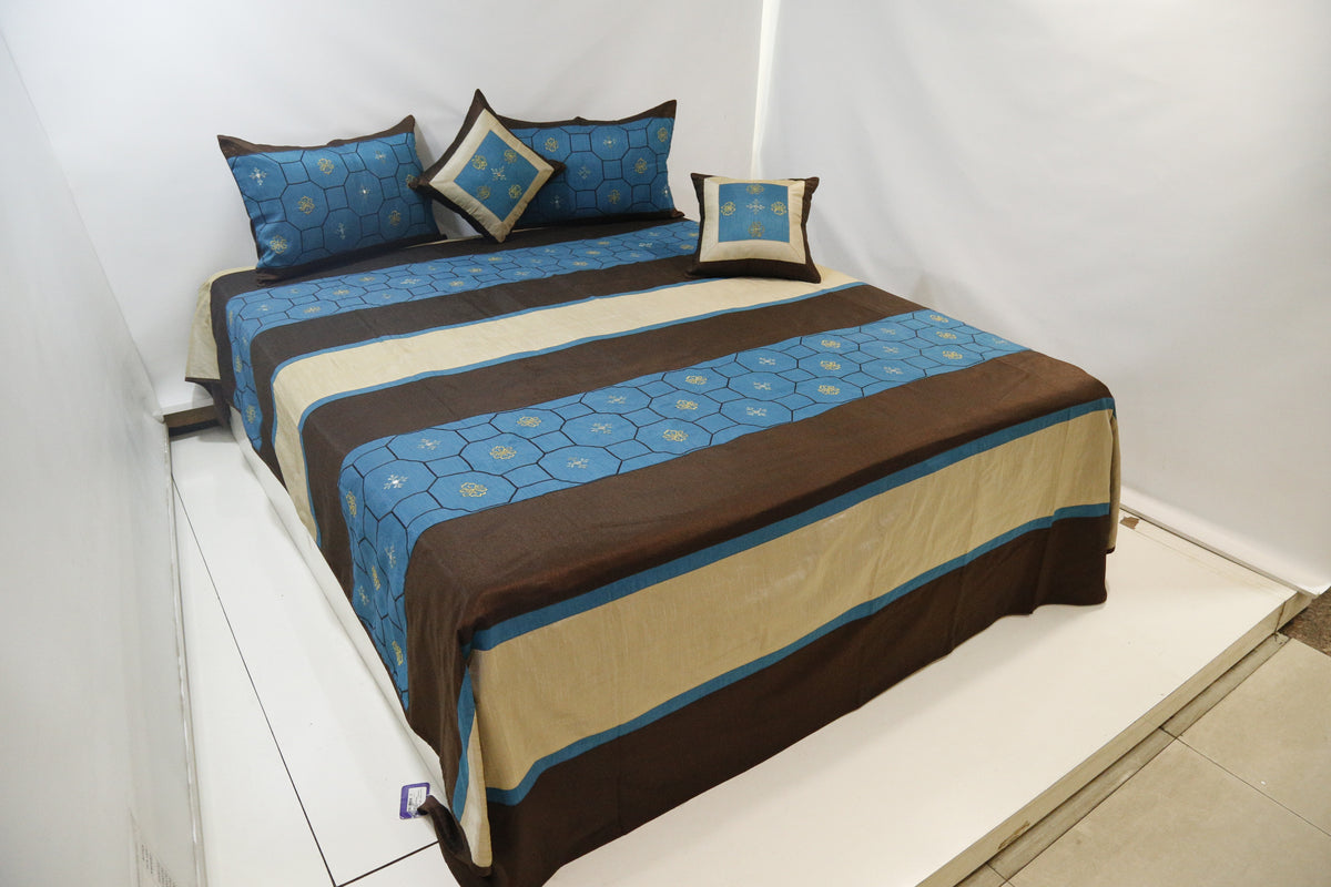 Angled view of the blue and brown striped dupion silk bedcover set on a double bed