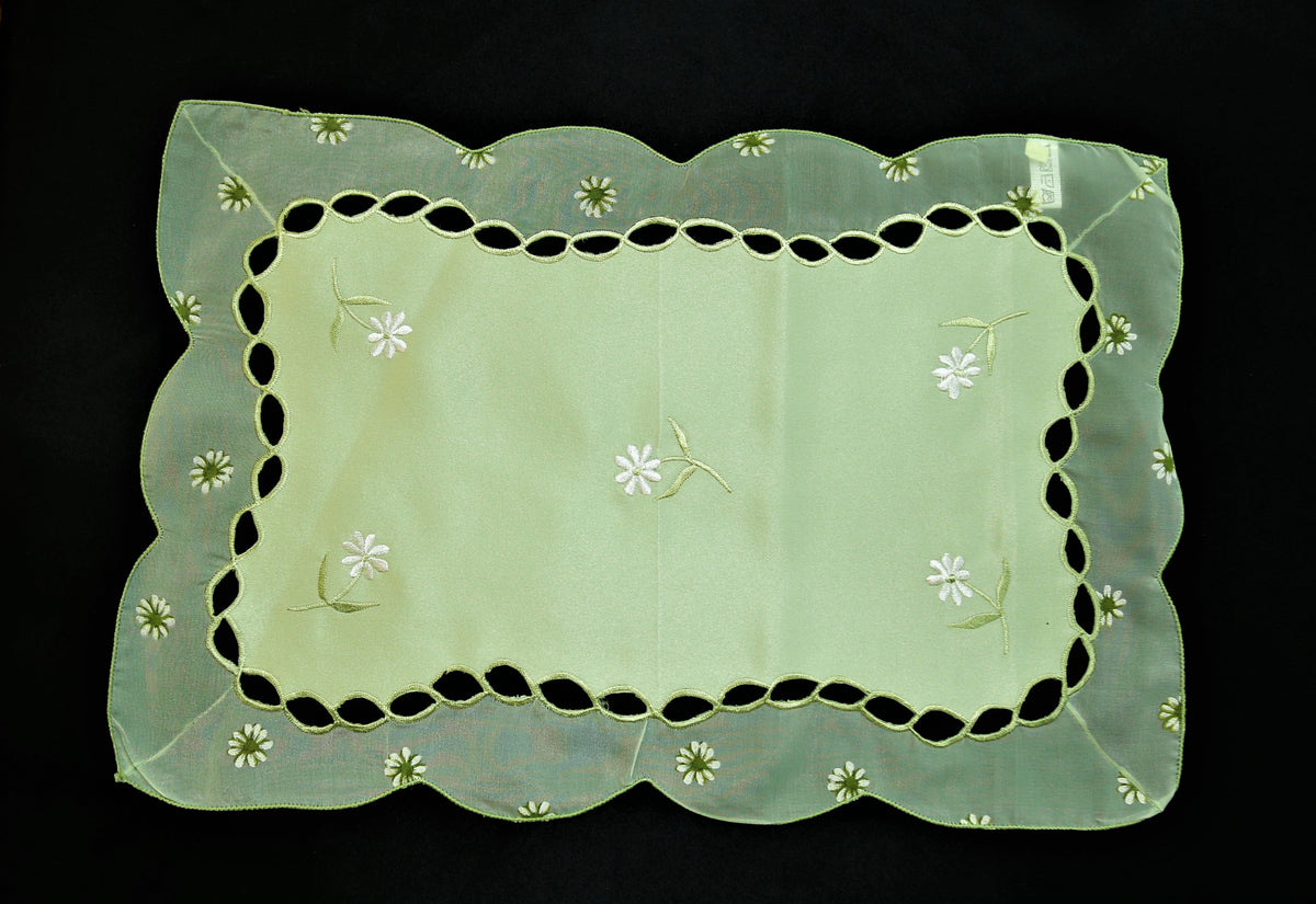 Green embroidered table mat close-up embroidery stitch detail