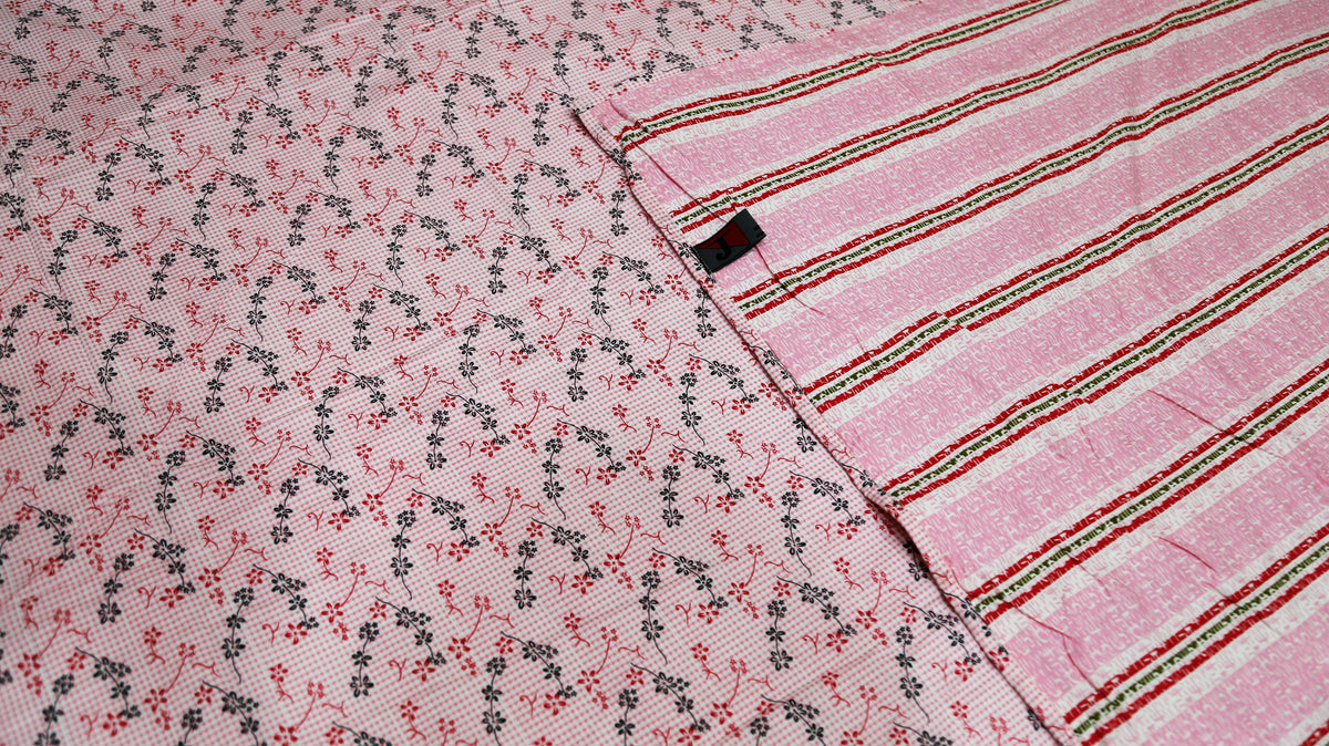 Close-up of the printed field meeting the woven pink and green striped border