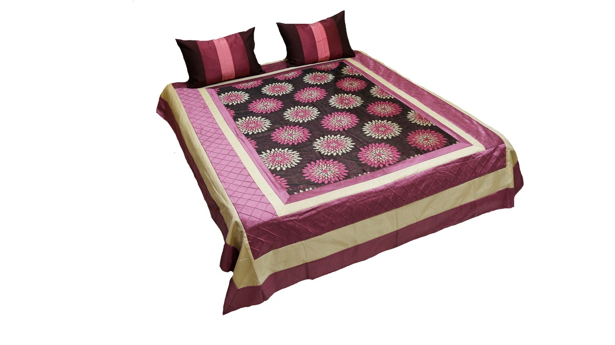 Wine and black bedcover with pink lotus medallions, cream border and two cushions