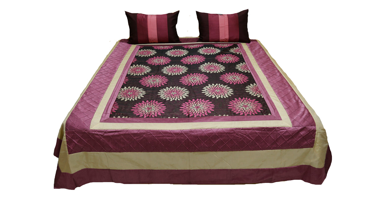 Wine bedcover with pink lotus medallion panel and striped cushion covers, straight view