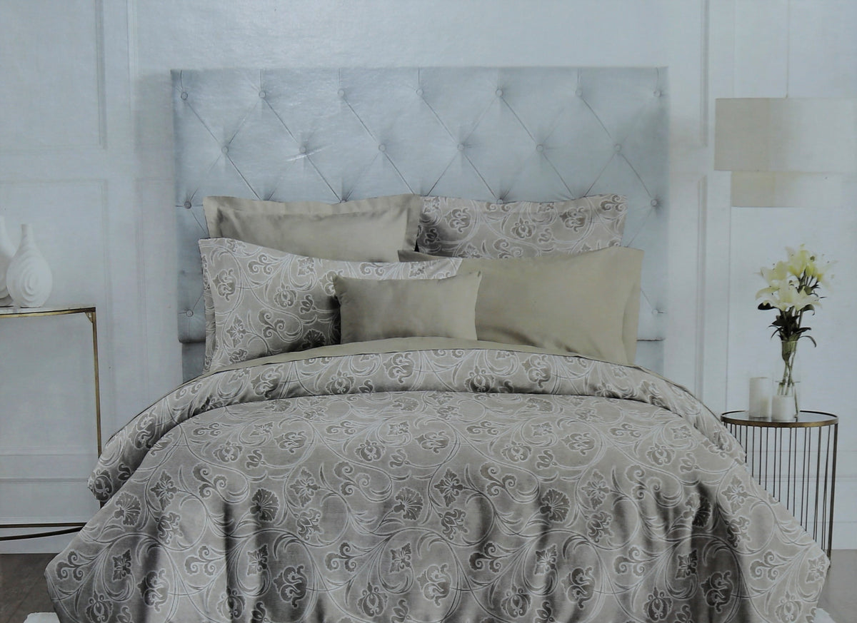 Grey paisley print cotton bedding made up on a tufted bed, Trident Nectarsoft