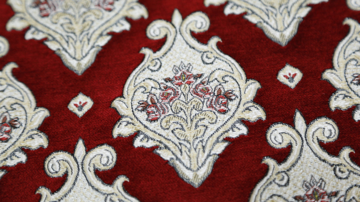 Closer crop of the red and cream damask medallion fabric on the quilted bedcover