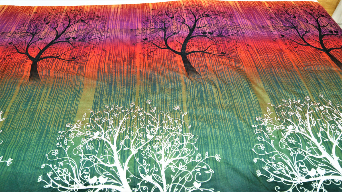 Close-up of dark tree silhouettes and white tree print on sunset ombre cotton