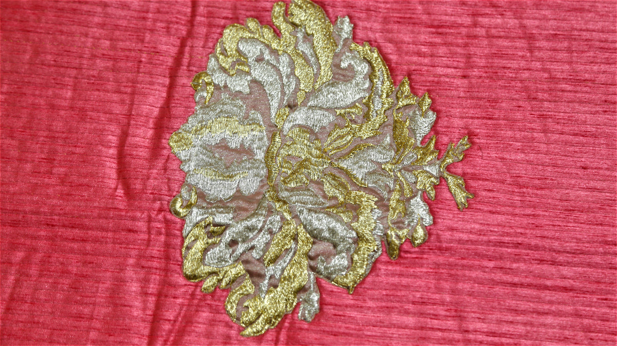 Close-up of gold and silver zari floral motif embroidered on coral rose silk