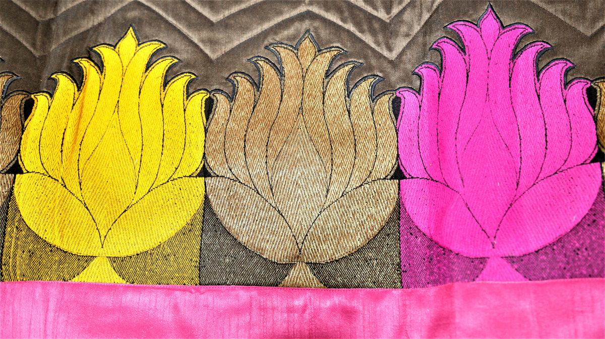 Close-up of gold, pink and yellow lotus applique on brown chevron velvet band