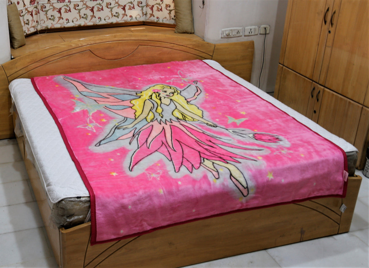 Hot-pink blanket with a printed fairy angel illustration in a flowing pink dress with wings, stars, and butterflies, spread on a bed