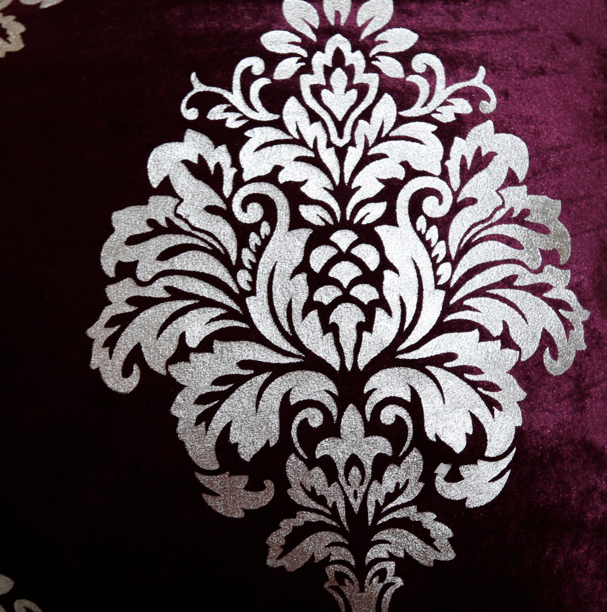 Close-up of the silver foil printed damask on wine velvet