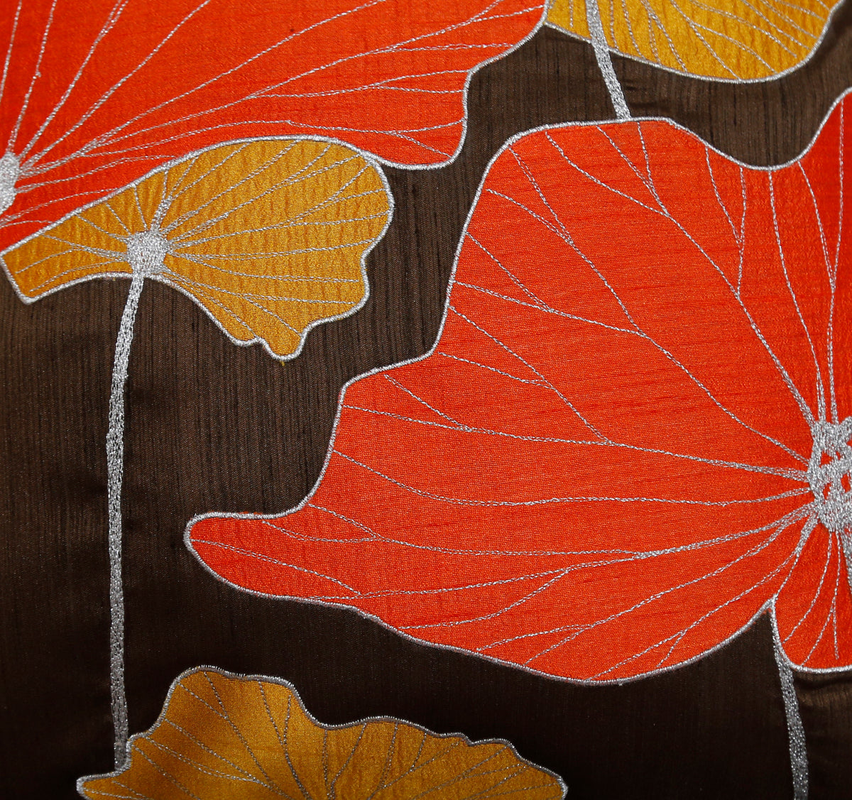 Close up of the orange and gold lotus leaf appliqué on a dark brown ground
