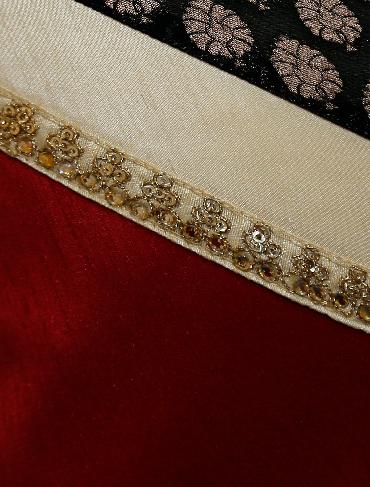 Close up of the diagonal join showing red silk, cream band and gold beaded trim