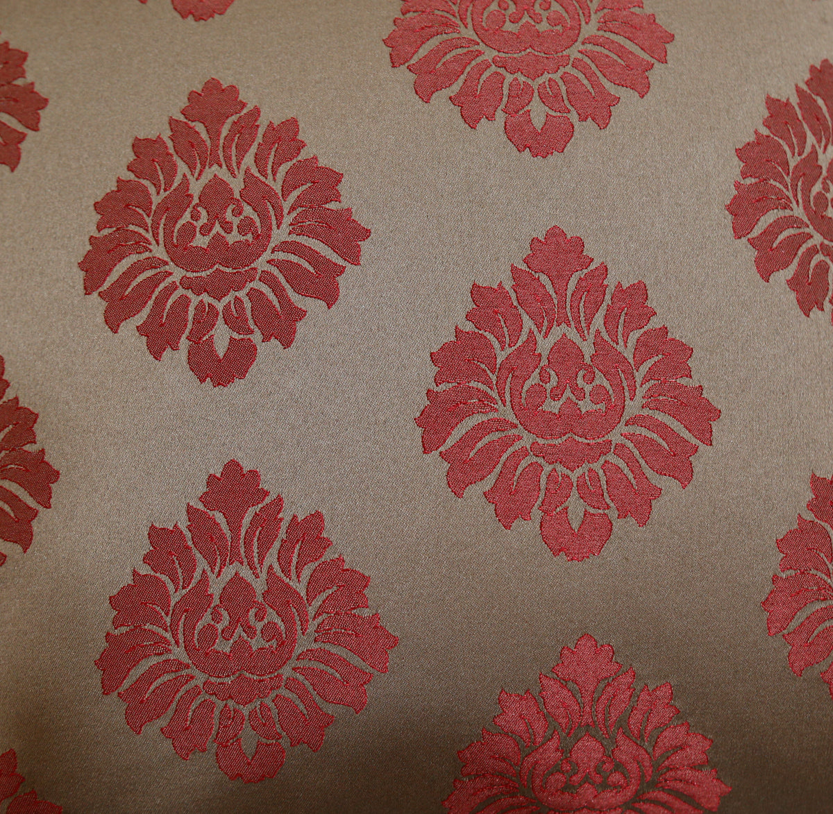 Close-up of the rust damask medallion woven on taupe