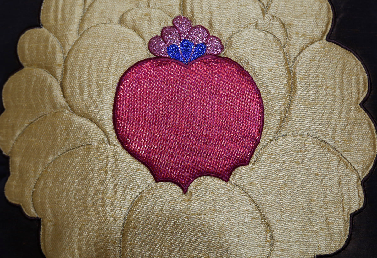 Close-up of the gold lotus appliqué with its beaded pink and blue centre