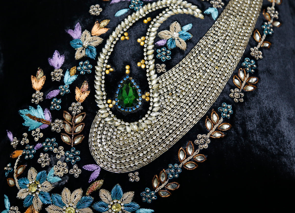 Close-up of the beaded paisley embroidery and green stone