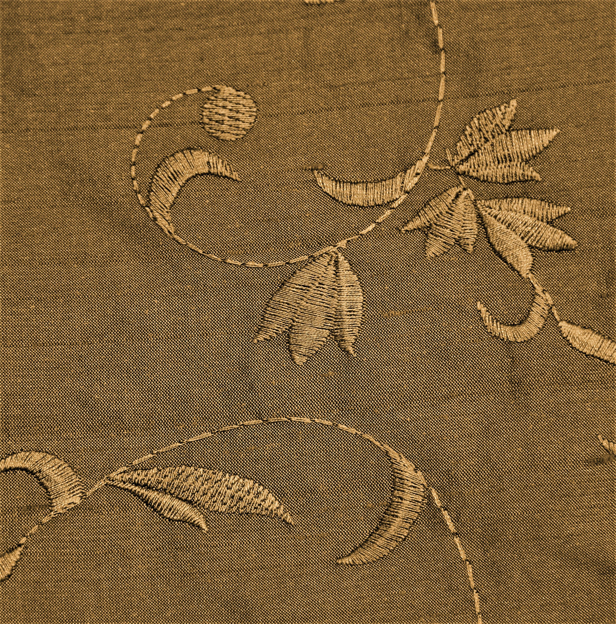 Rust-beige polysilk upholstery fabric with a tone-on-tone embroidered floral vine