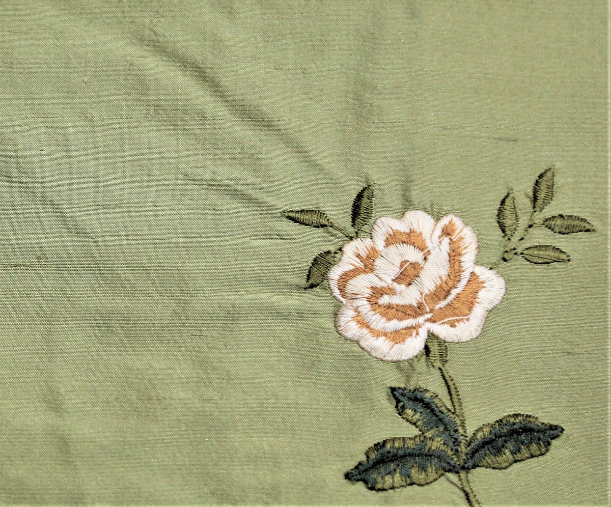 Sage-green silk upholstery fabric with an embroidered rose motif in cream and tan