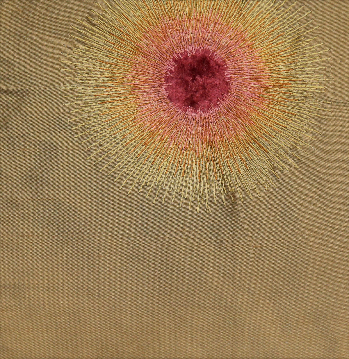 Tan silk upholstery fabric with a garnet-rose and gold embroidered sunburst motif