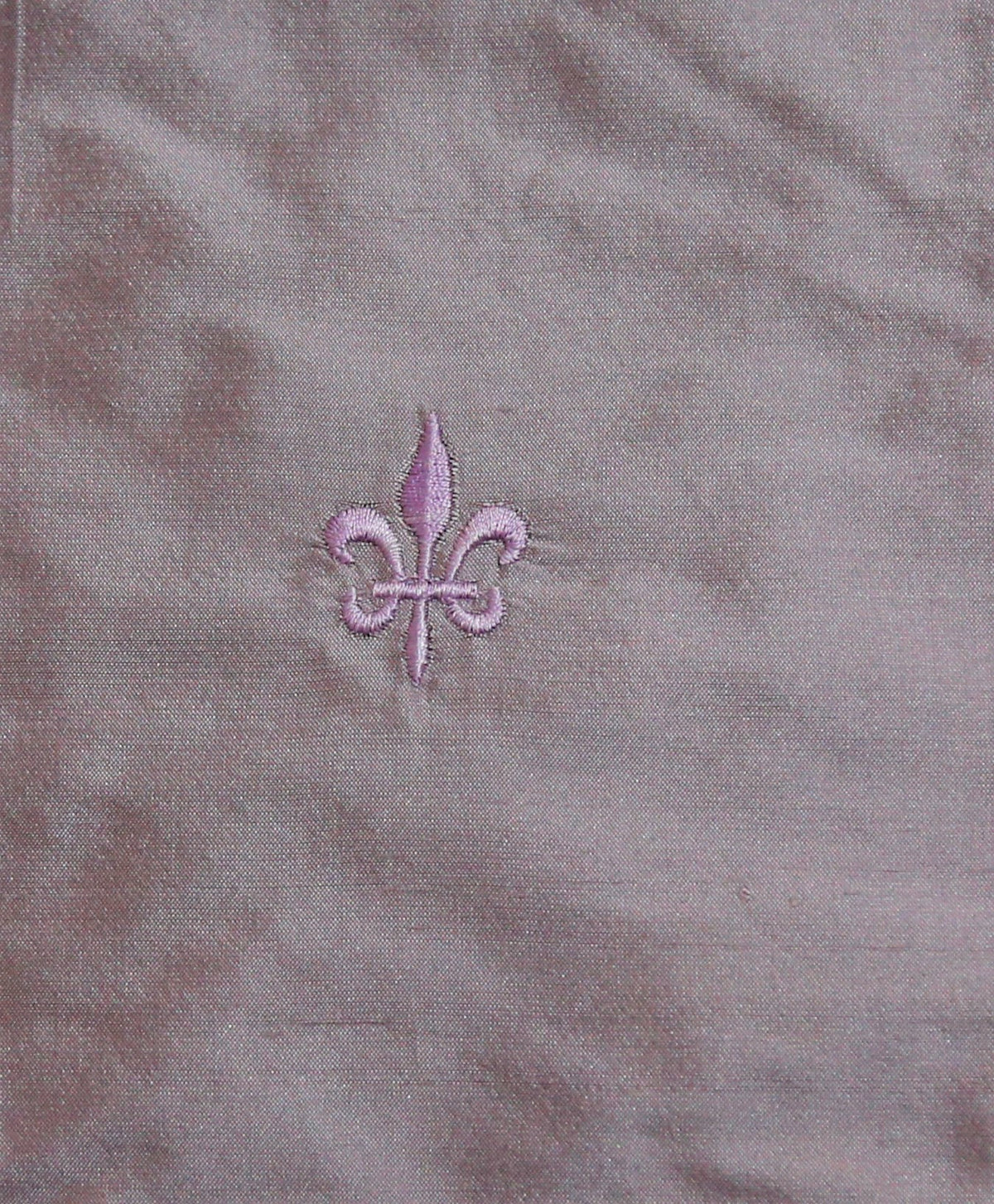 Mauve polysilk upholstery fabric with a tone-on-tone embroidered fleur-de-lis motif