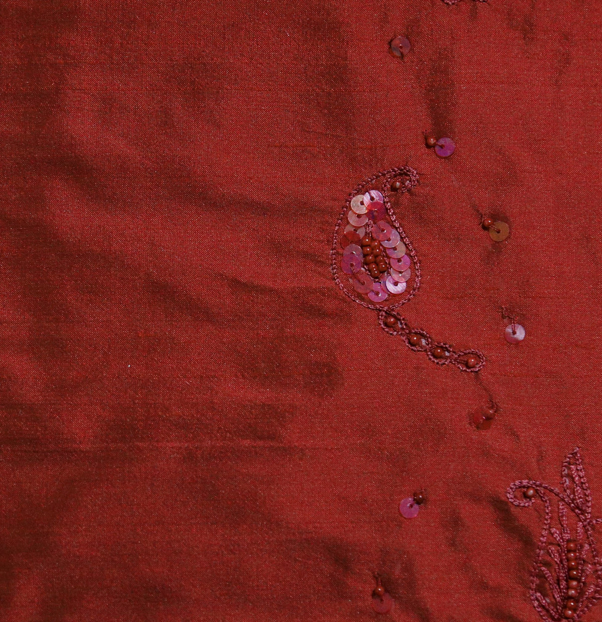 Maroon polysilk upholstery fabric with tone-on-tone sequin and bead embroidered paisley motifs