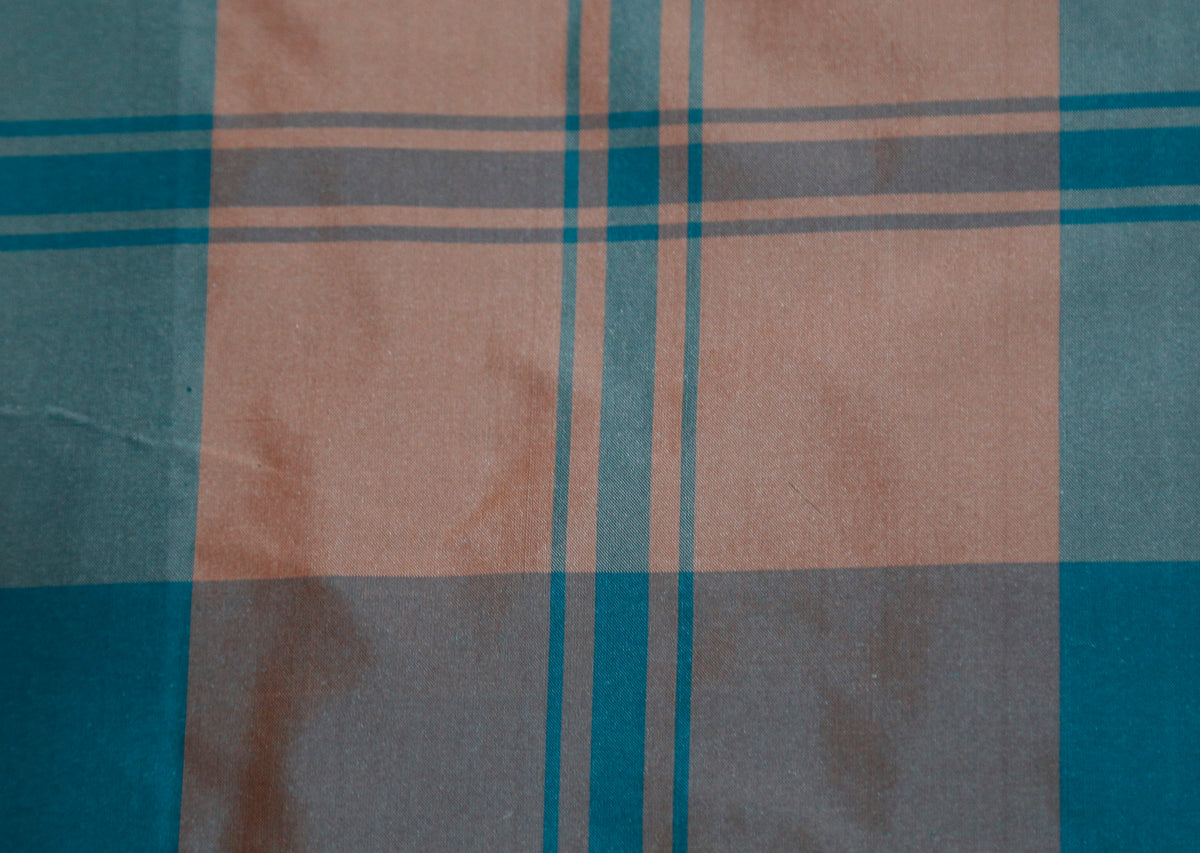Cinnipatta silk upholstery fabric swatch in dusty peach and slate blue check