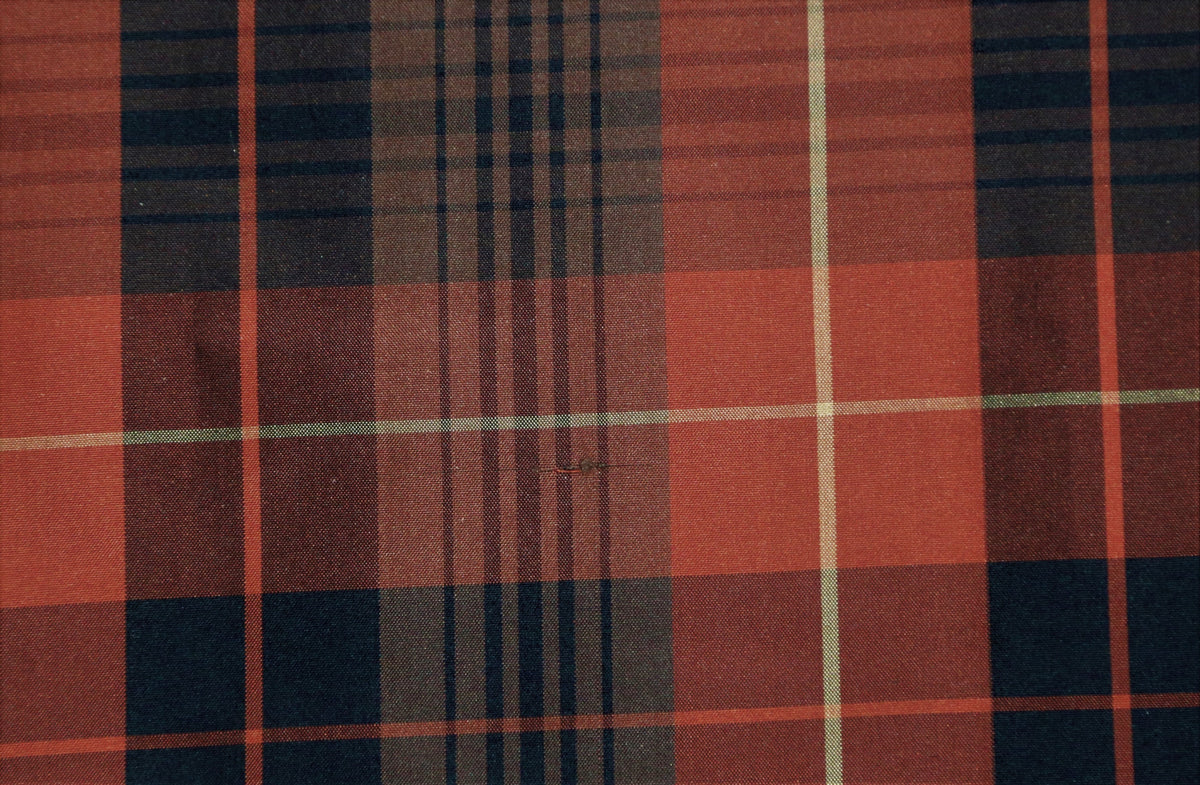 Rust-orange and black polysilk upholstery fabric in a windowpane check