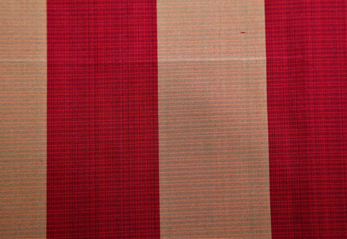Deep red and peach-orange silk upholstery fabric in a colour-block stripe