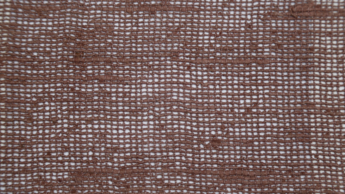 Terracotta silk upholstery fabric in an open sheer weave