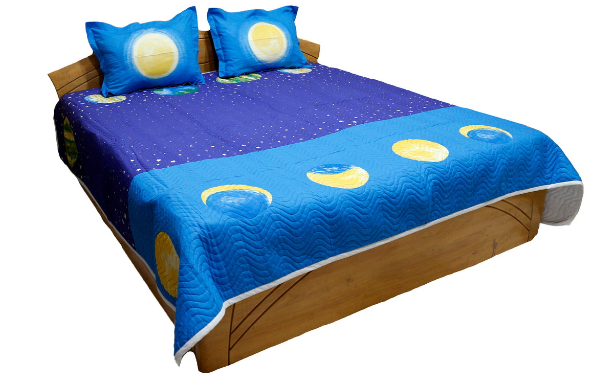 Blue children's bedcover printed with moons, planets and stars, angled view